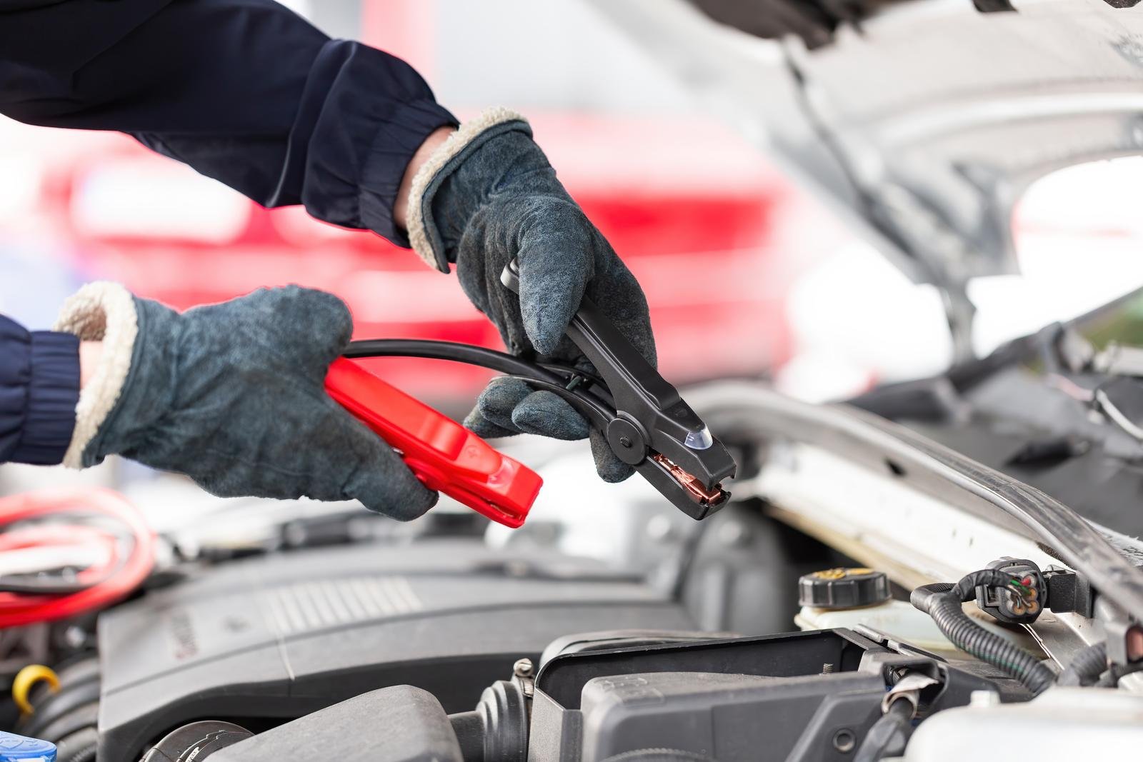 Jumper cables clamped to a car battery