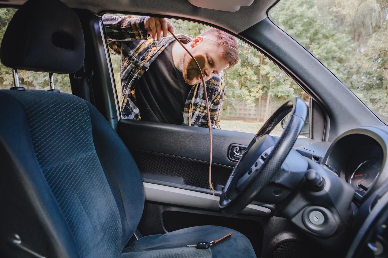Technician unlocking a car door with lockout tools